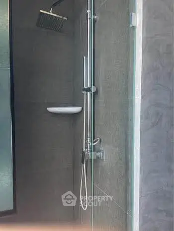 Modern bathroom shower with sleek glass enclosure and rainfall showerhead