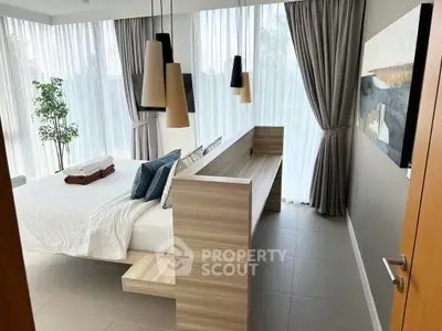 Luxurious bedroom with modern decor and large windows for natural light