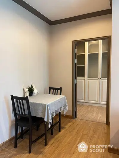 Cozy dining nook with wooden flooring and elegant storage cabinets