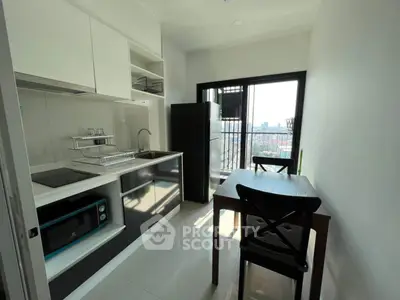 Modern kitchen with sleek appliances and city view from balcony