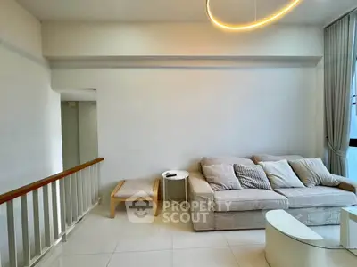 Modern living room with cozy sofa and elegant lighting