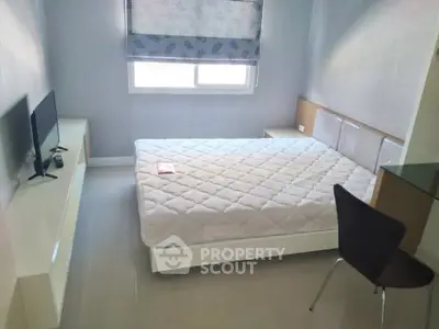 Cozy bedroom with modern furnishings and natural light