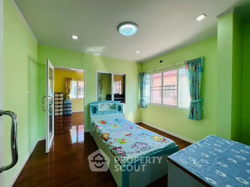 Bright and cheerful bedroom with colorful decor and ample natural light