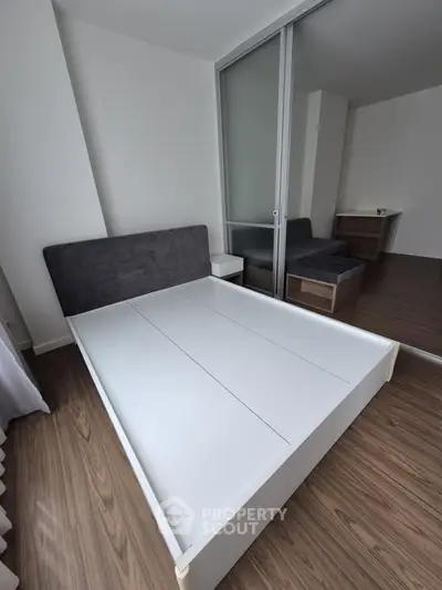 Modern bedroom with sleek design and wooden flooring