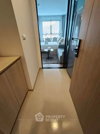 Modern apartment entrance leading to a cozy living room with stylish decor.