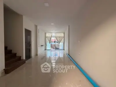 Spacious unfurnished interior with glossy floors and large windows, ideal for customization.