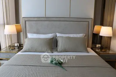 Luxurious bedroom with elegant decor and plush bedding in a modern real estate property.