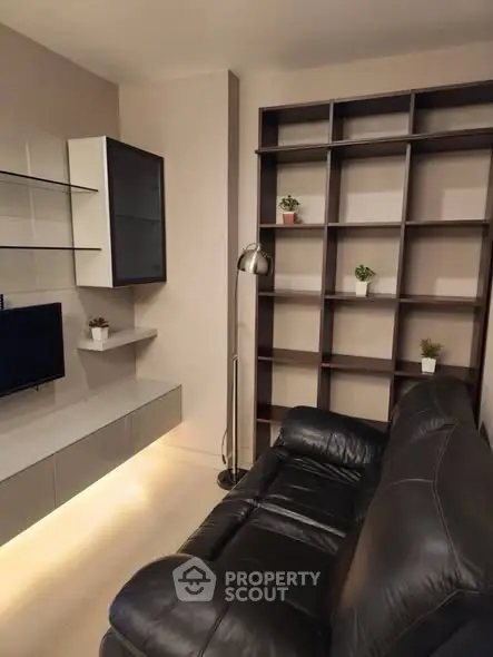 Modern living room with sleek shelving and cozy leather sofa
