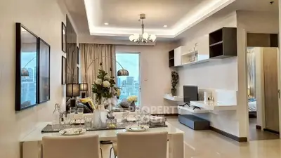 Modern open-plan living and dining area with city view, elegant decor, and stylish furnishings.