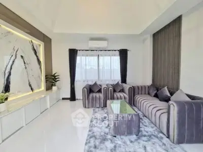 Luxurious modern living room with elegant marble feature wall and plush grey seating.