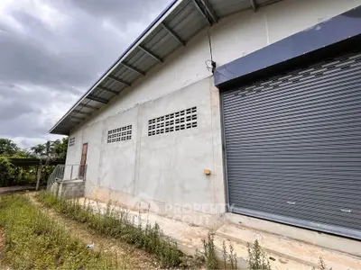 Spacious industrial warehouse with secure roller door and ample outdoor space.