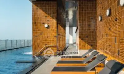 Luxurious rooftop pool with modern design and sun loungers, perfect for relaxation.