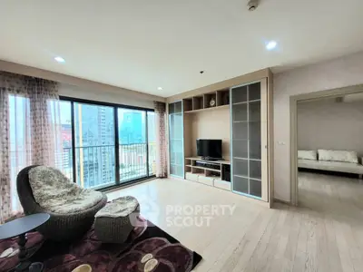 Spacious living room with city view and modern furnishings in high-rise apartment