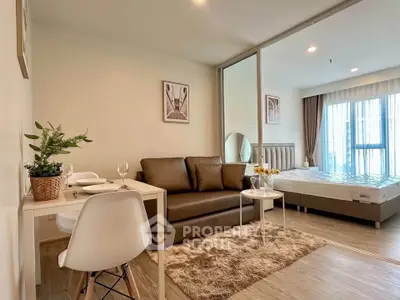 Modern studio apartment with cozy living area and stylish bedroom, featuring elegant decor and natural light.