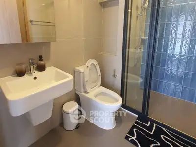 Modern bathroom with sleek fixtures and glass shower enclosure