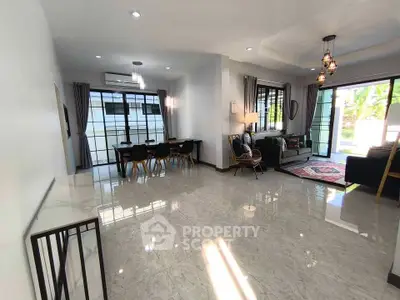 Spacious modern living room with elegant dining area and large windows for natural light.