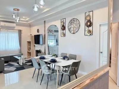 Elegant dining and living area with modern decor and natural light