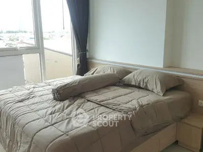 Modern bedroom with large window and neutral decor in urban apartment