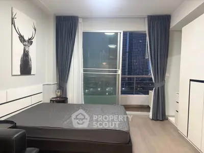 Modern bedroom with city view and stylish decor in a high-rise apartment.