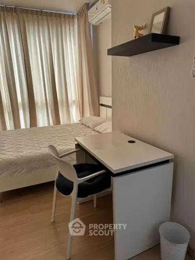 Cozy bedroom with study desk and modern decor, perfect for urban living.