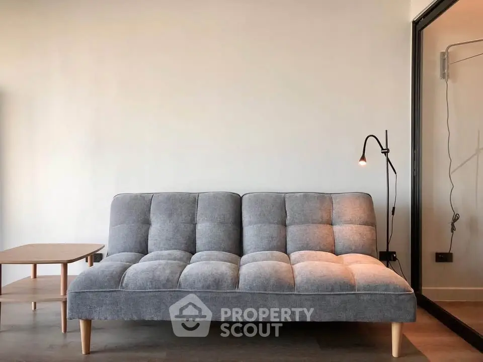 Modern living room with stylish gray sofa and sleek floor lamp