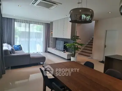 Spacious modern living room with stylish furniture and natural light, perfect for family gatherings.