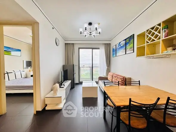 Modern living room with dining area and balcony view in stylish apartment.