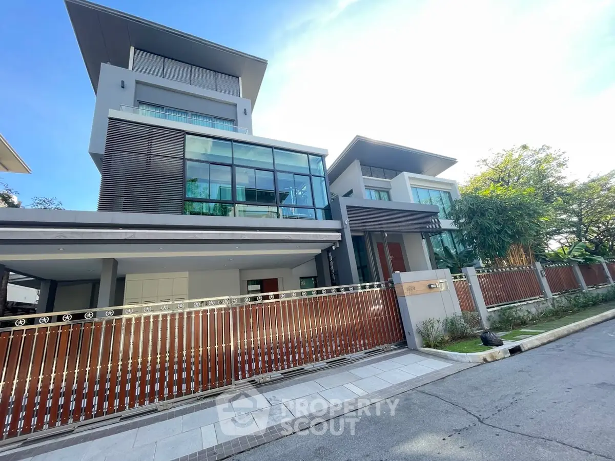 Luxurious modern house with sleek design and spacious balconies in a serene neighborhood.
