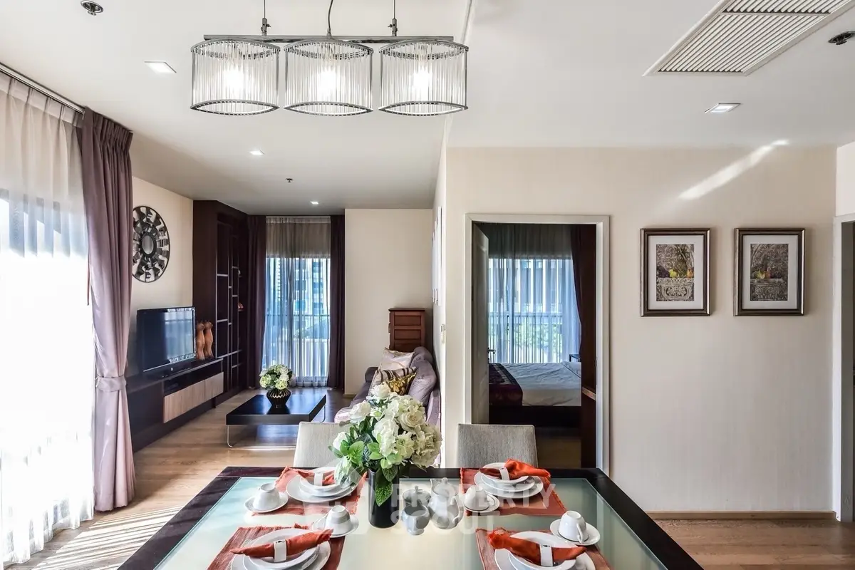 Elegant open-plan living and dining area with modern decor and natural light.