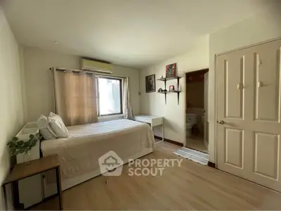Cozy bedroom with ensuite bathroom and natural light