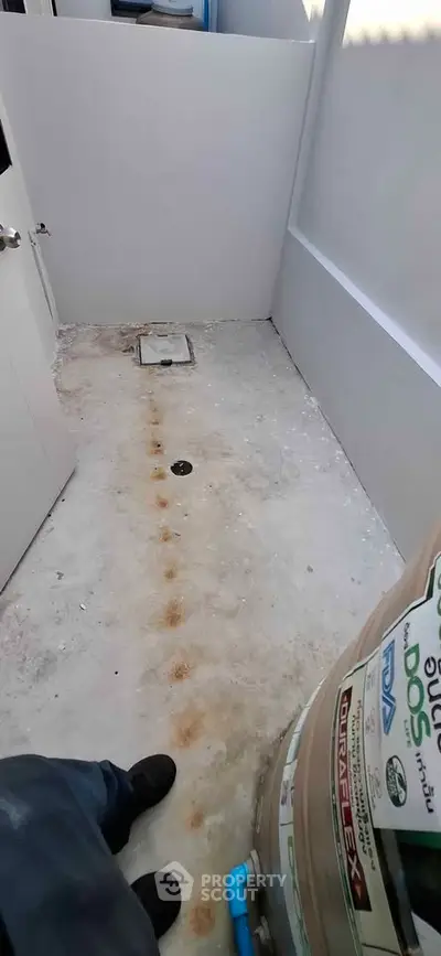 Unfinished bathroom space with exposed plumbing and construction materials.