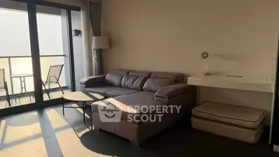 Modern living room with cozy sectional sofa and balcony view