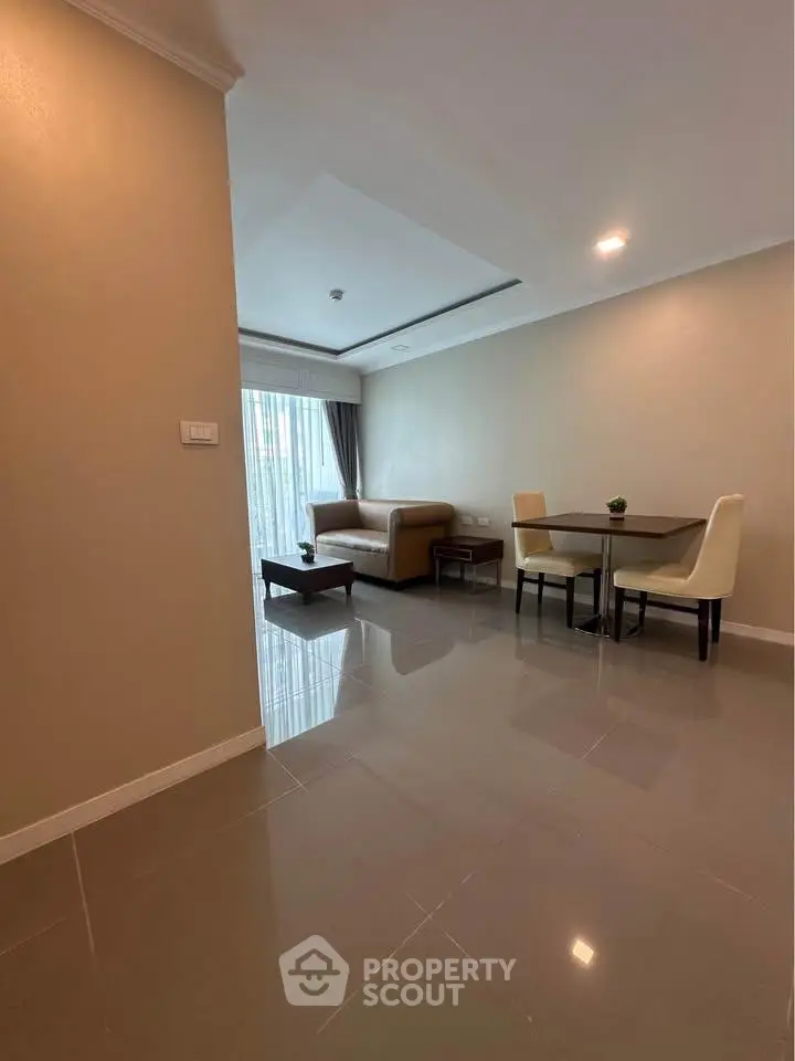 Spacious living room with modern furniture and natural light, perfect for relaxation and entertaining.