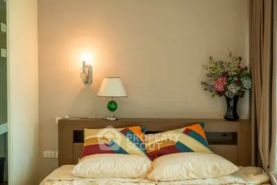 Cozy bedroom with stylish decor and warm lighting, perfect for relaxation and comfort.