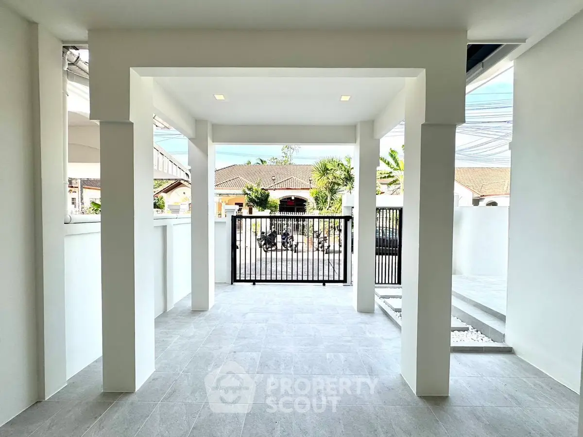 Modern home entrance with sleek design and spacious outdoor area