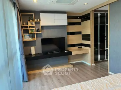 Modern bedroom with stylish wooden accents and built-in TV unit