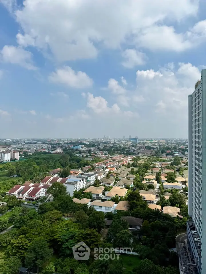 Stunning aerial view of suburban neighborhood with lush greenery and clear blue sky.
