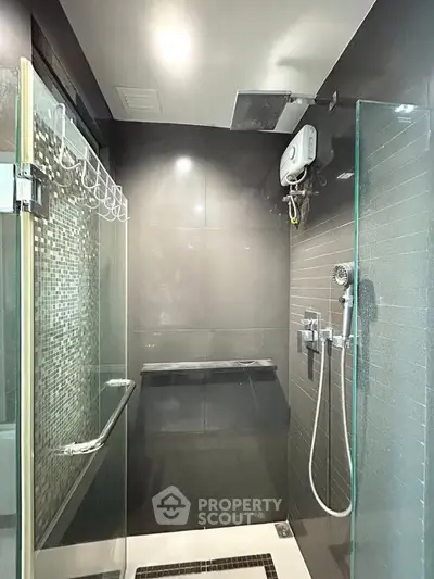 Modern bathroom with glass shower enclosure and sleek fixtures