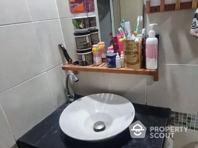 Modern bathroom sink with stylish countertop and organized toiletries