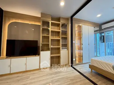 Modern bedroom with built-in storage and sleek design in a high-rise apartment.
