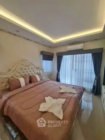 Luxurious bedroom with elegant decor and large windows for natural light.