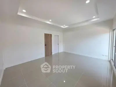Spacious modern living room with sleek tile flooring and recessed lighting