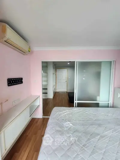Spacious bedroom with air conditioning and modern decor in a stylish apartment.