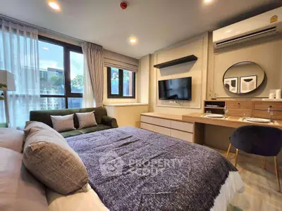 Modern bedroom with stylish decor and natural light