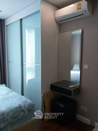 Modern bedroom with sliding closet doors and air conditioning unit
