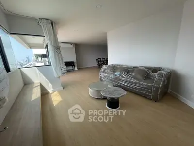 Spacious modern living room with city view and elegant furnishings