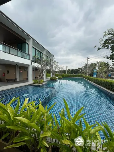 Luxurious residential pool with modern architecture and lush greenery