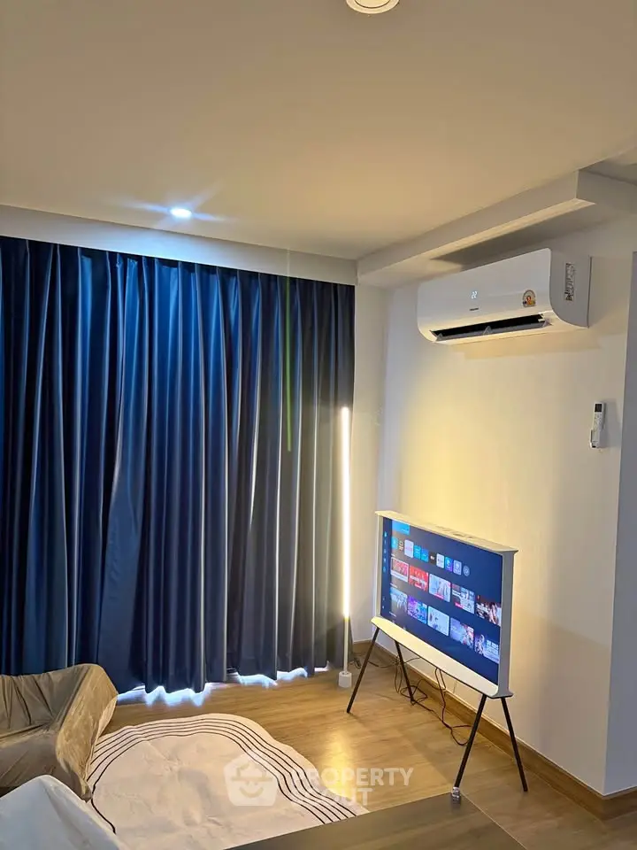 Modern living room with sleek air conditioning and stylish TV setup, perfect for entertainment and relaxation.