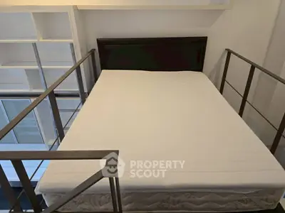 Modern loft bedroom with sleek metal railing and minimalist design