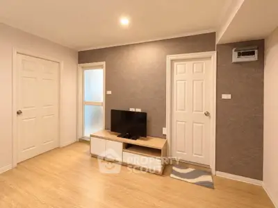 Modern living room with wooden flooring and stylish TV unit
